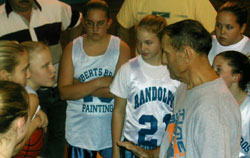 Roberts talks with the girls' 7th grade basketball team. Photo by Jesse Raymond.