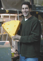 At the Foamation Inc. factory, Ralph Bruno shows off a Cheesehead. Photo by Michelle Wexler
